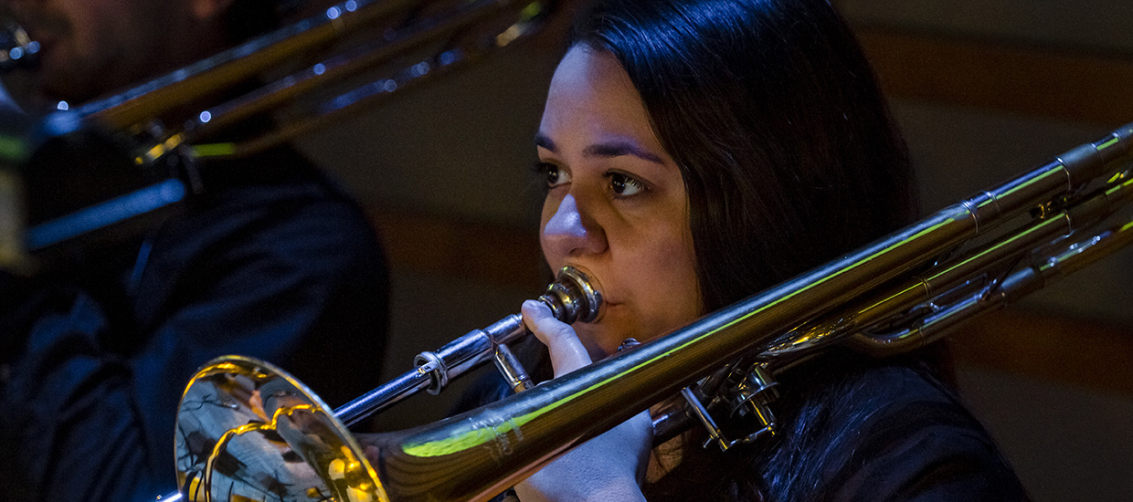 Musician performs with a trombone live in concert