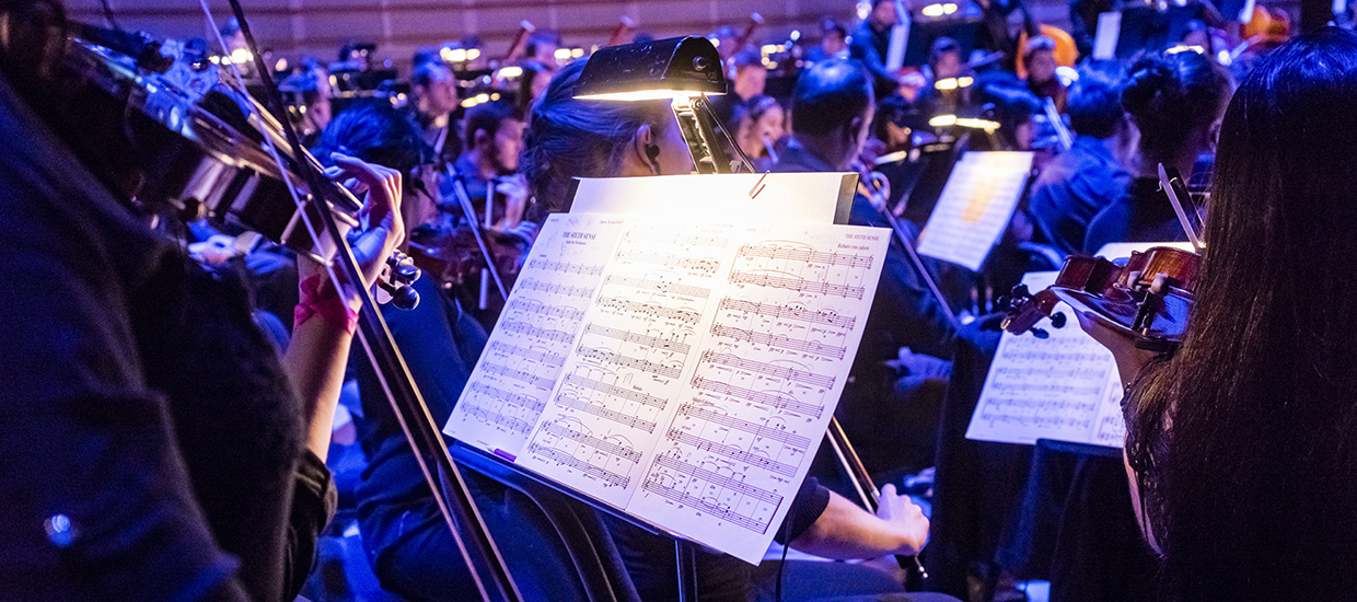 A violinist's sheet music while performing with the orchestra