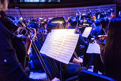 A violinist's sheet music while performing with the orchestra