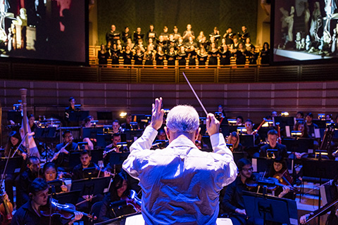 Conductor directs the orchestra at the University of Miami